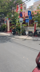 Morning commuter traffic filmed at decorated Nha Trang roundabout