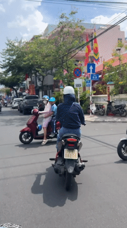 Morning commuter traffic filmed at decorated Nha Trang roundabout