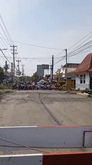 Train crosses through Kebonsari blocking morning traffic
