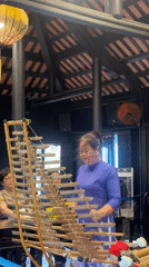 Woman plays traditional Vietnamese bamboo xylophone in Nha Trang