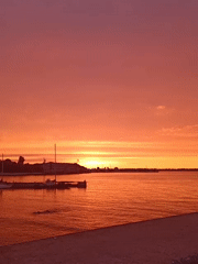 Baltic sunset over Tallinn's harbor, boats and skyline in view