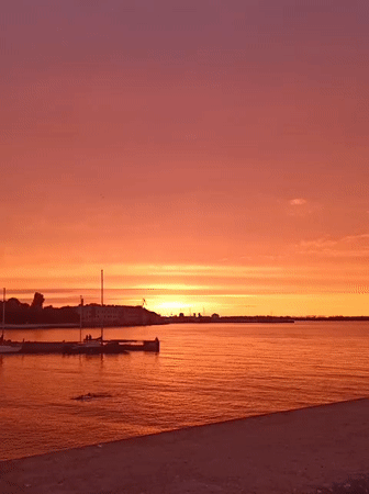 Baltic sunset over Tallinn's harbor, boats and skyline in view