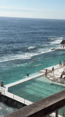 Swimmers and yoga practitioners enjoy sunny day at Bondi Icebergs