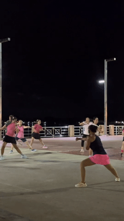 Night aerobics class on Surat Thani's riverside promenade