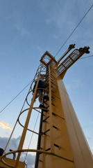 Climbing a ship's mast structure off the Indonesian coast