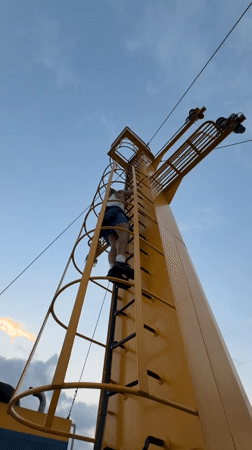 Climbing a ship's mast structure off the Indonesian coast