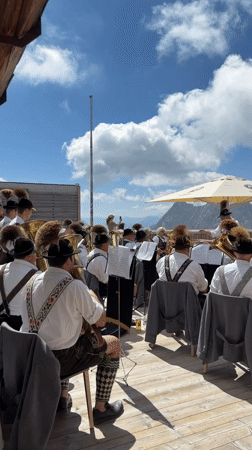 Brass band and alpine dining on a sunny Austrian mountainside