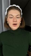 Woman applies skincare cream in Kazan morning routine