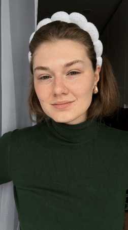 Woman applies skincare cream in Kazan morning routine