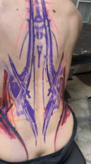 Tattoo session documented in Moscow featuring large colorful back piece