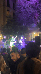 Four-piece band performs outdoor concert in Barcelona under purple lights