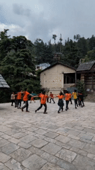Students circle up in a Naggar temple courtyard