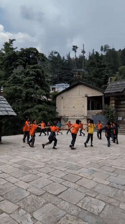 Students circle up in a Naggar temple courtyard