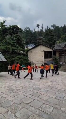 Students circle up in a Naggar temple courtyard