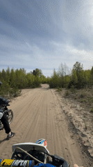 Motorcyclists ride sandy woodland trail near Dubrovka, Russia