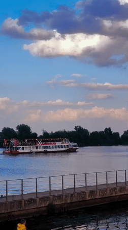 Summer afternoon on the Riga river, swimmers and boats everywhere