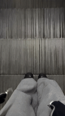 Buenos Aires evening observations capture escalator rider, message t-shirt
