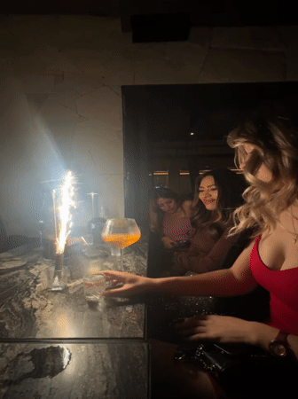 Women celebrate with sparkler at Mexico City restaurant