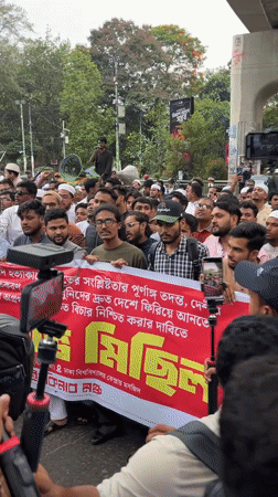 Large crowd protests in Dhaka streets beneath overpasses