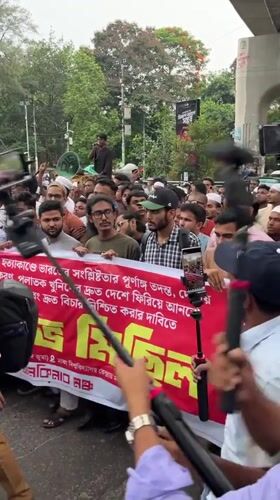 Large crowd protests in Dhaka streets beneath overpasses