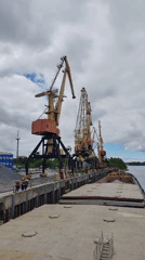 Workers and cargo barges active at Rybinsk river port
