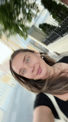 Woman takes selfies near Moscow cathedral and Yandex Market