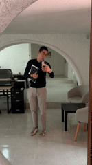 Man records selfie video with devices in Puebla mirror