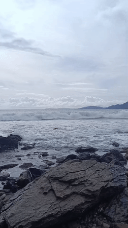 Rocky shoreline scene captured in Naga Umbang, Indonesia