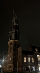 Amsterdam clock tower and street architecture documented at night