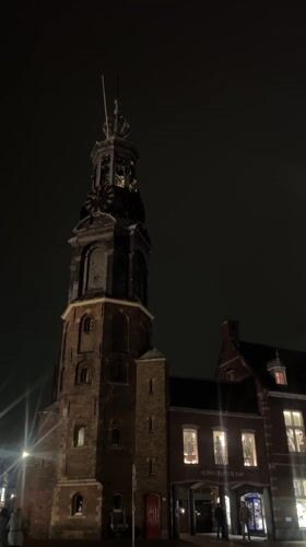 Amsterdam clock tower and street architecture documented at night