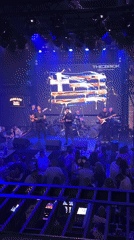 Six-piece band performs under blue lights in Varna venue