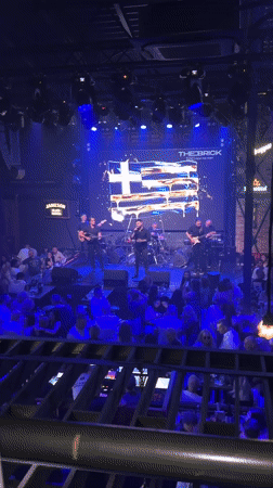 Six-piece band performs under blue lights in Varna venue