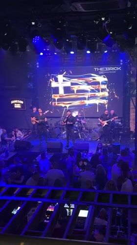 Six-piece band performs under blue lights in Varna venue