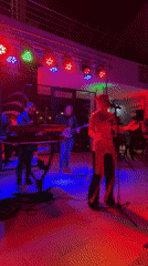 Live band with female vocalist performs outdoor evening show in Bar