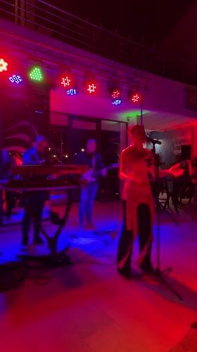 Live band with female vocalist performs outdoor evening show in Bar