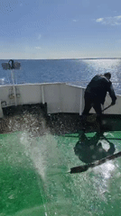 Deck cleaning observed on Russian vessel during sunny afternoon