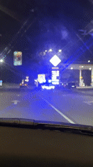 Police car with flashing lights stationed at Burgas intersection