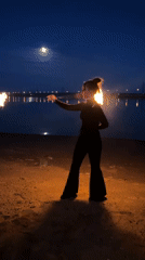 Fire dancer performs nighttime show on Russian beach