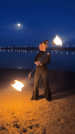 Fire dancer performs nighttime show on Russian beach