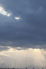 Shifting clouds and sunbeams over Rubtsovsk on a dramatic afternoon