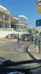 Children serve as crossing guards in Tel Mond street
