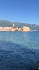 Tourist enjoys sunny afternoon at rocky Budva beach