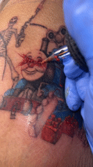 Tattoo artist works with red ink in Buenos Aires