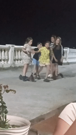 Family evening gathering with children, baby, dog on Sochi promenade