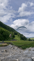 Paragliders soar over Swiss mountains near Schwende-Rüte