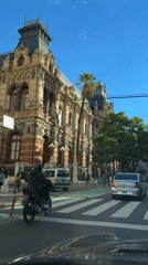 Buenos Aires street life: scooters, pedestrians under sunny skies