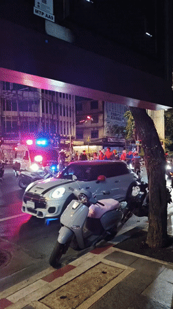 Emergency response at Bangkok intersection amid evening street activity