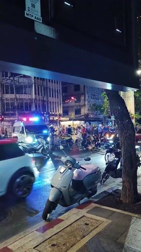 Emergency response at Bangkok intersection amid evening street activity