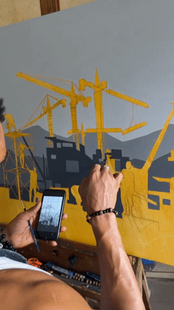 Artist paints construction cityscape using phone reference in Ado