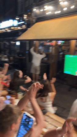 London crowd celebrates outdoors during a late-night sporting event